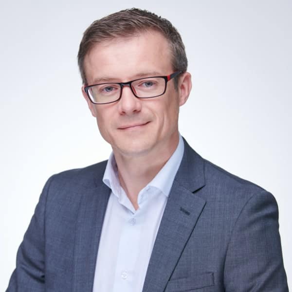 A man in glasses is posing for a photo.