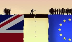 British and eu flags with people standing on the edge of a cliff.